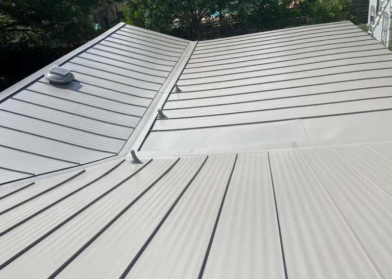 Solar attic fan installed on a metal roof for Roof Ventilation in Florence